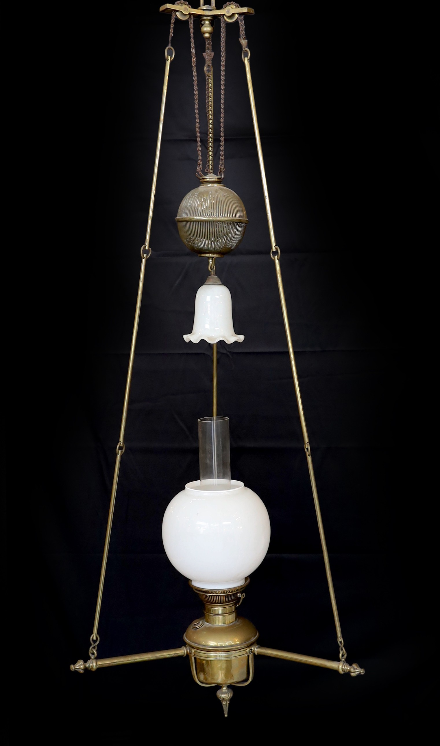 A Victorian Hinks brass counterbalanced hanging oil lamp with opaque glass shade and fluted balance weight, height 140cm, width 55cm